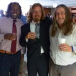 Three men and a woman with drinks.