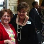 Women smiling at a business event.