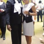 Two women wearing black and white outfits.