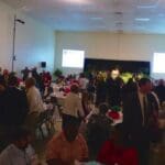 Large group gathering in a banquet hall.