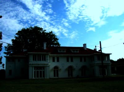 Historic mansion with cloudy sky