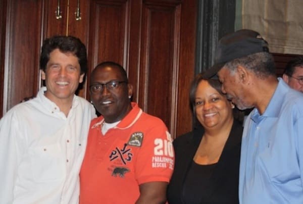 Group of four people smiling together