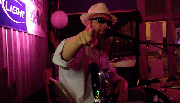 Man in hat playing music at event