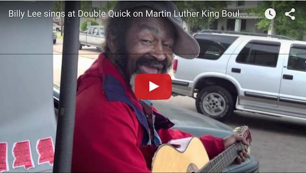 Smiling guitarist in a red jacket