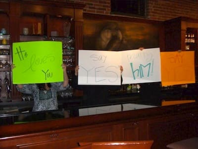 Signs held up lovingly by staff at Madidi while Poor William made his proposal. Photo by Delta Bohemian
