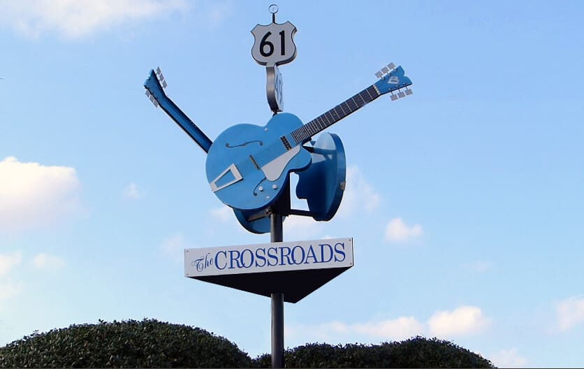 Crossroads signpost with large blue guitar