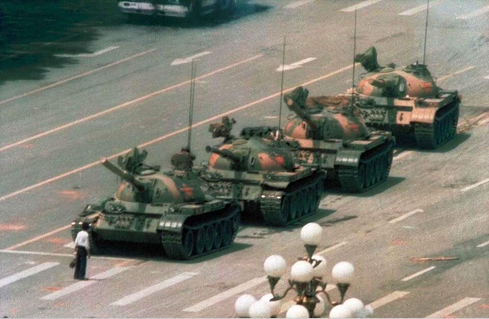 Man standing in front of tanks.