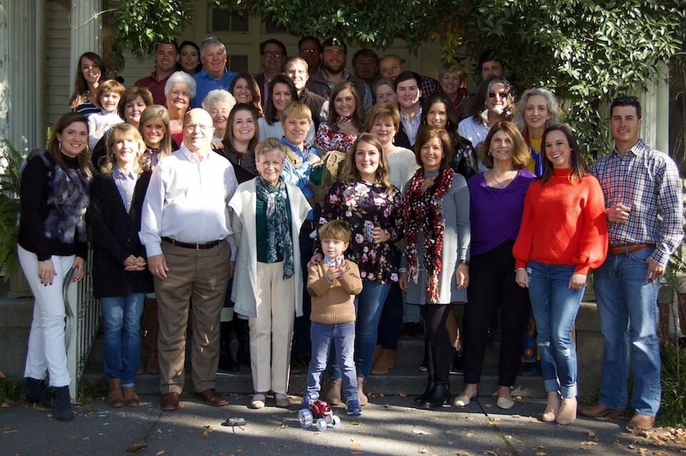 Large family group portrait outside house