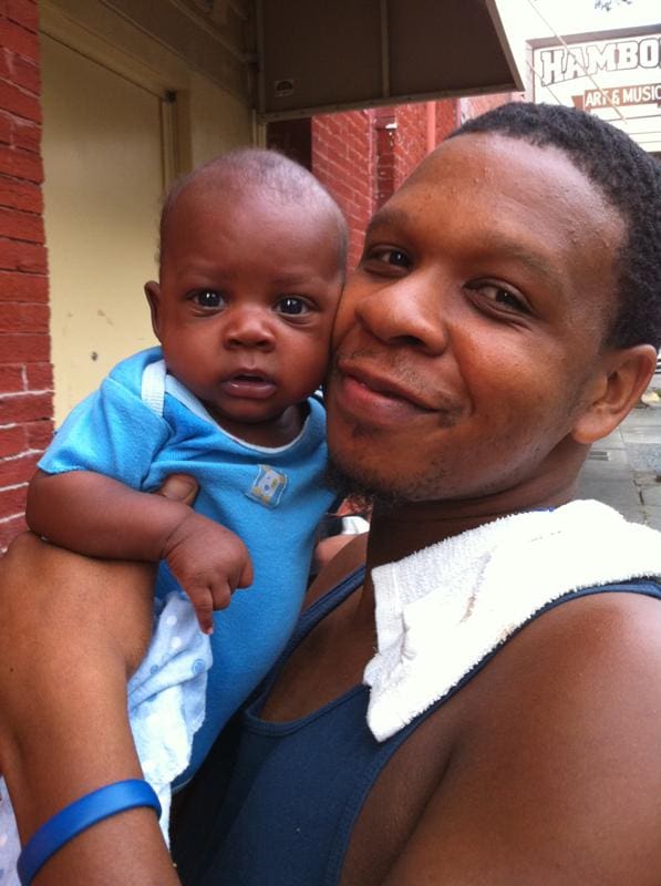 Smiling dad with infant son