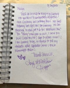 Handwritten thank you note on a spiral notebook.