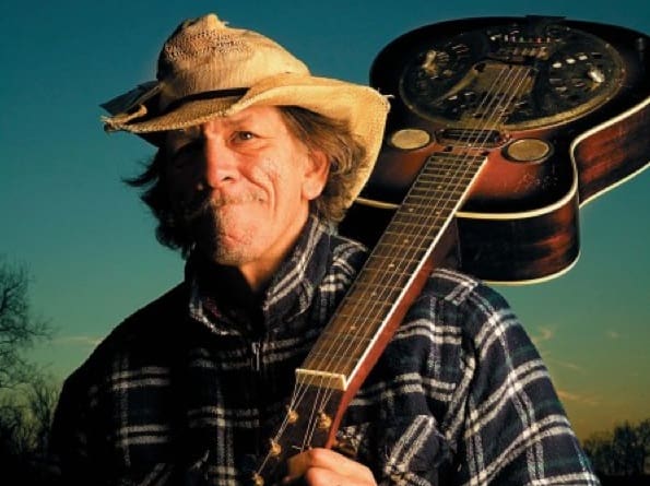 Musician holding guitar outdoors