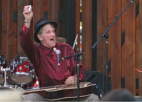 Musician performing energetically on stage