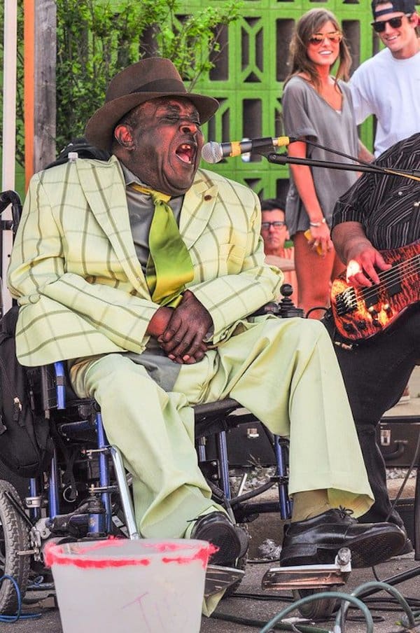 Man in plaid suit performing music