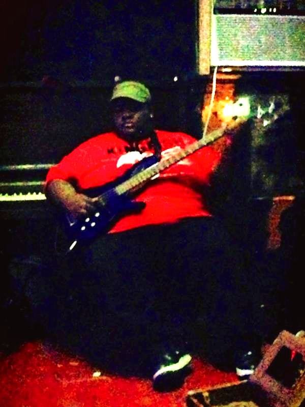 Musician with guitar near piano