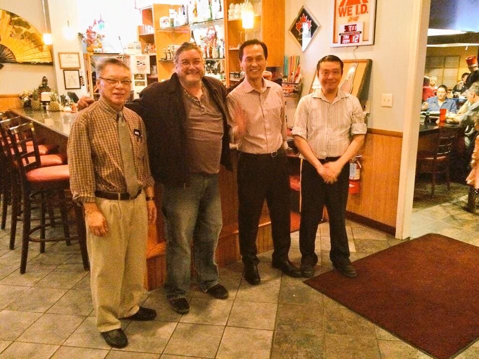 Smiling group gathered near bar counter