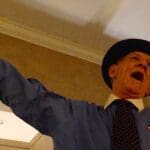 Man in hat with microphone speaking