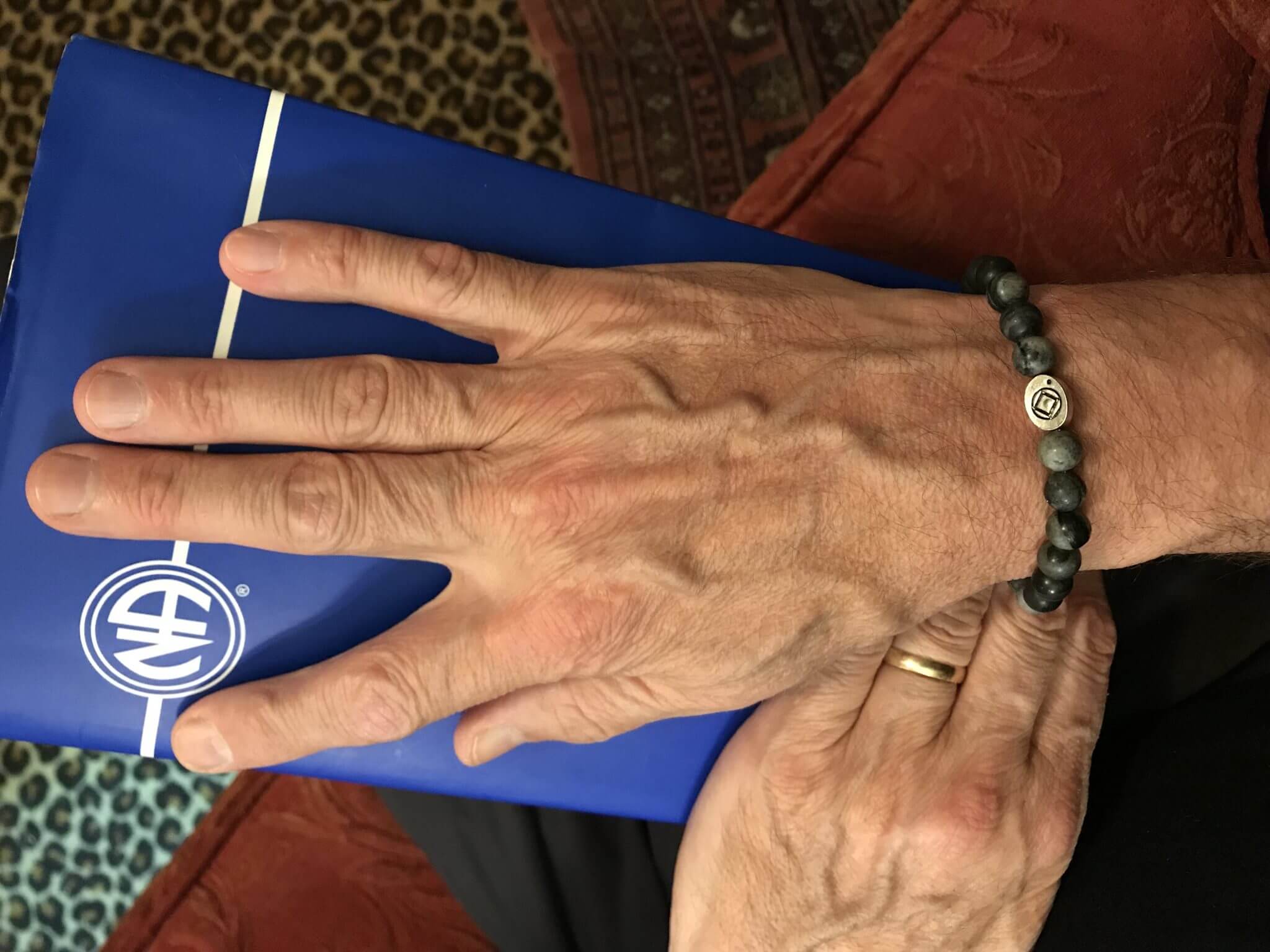 Man's hand with bracelet and package