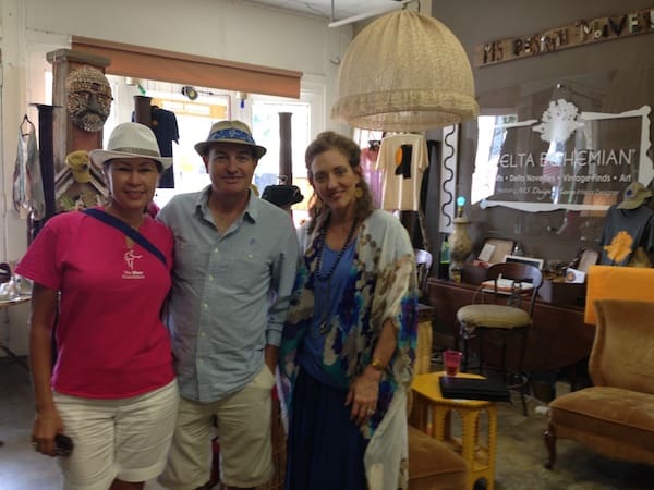 Three people posing in a shop