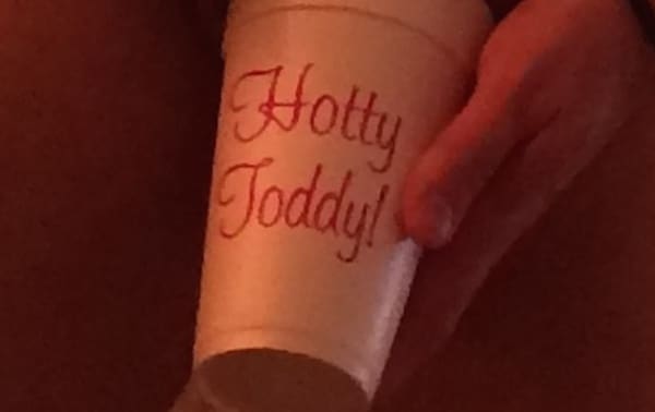 Hand holding a "Hotty Toddy" cup