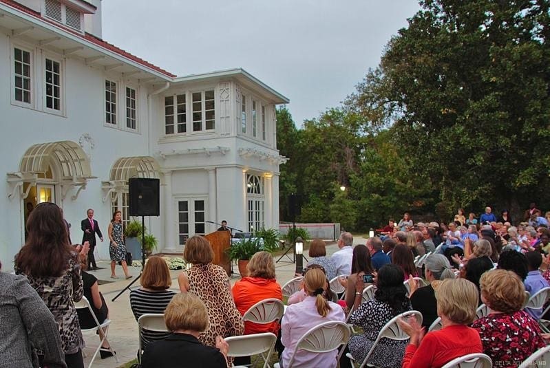 Outdoor event at historic white building