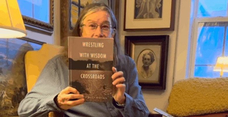 Person holding a book in cozy room.