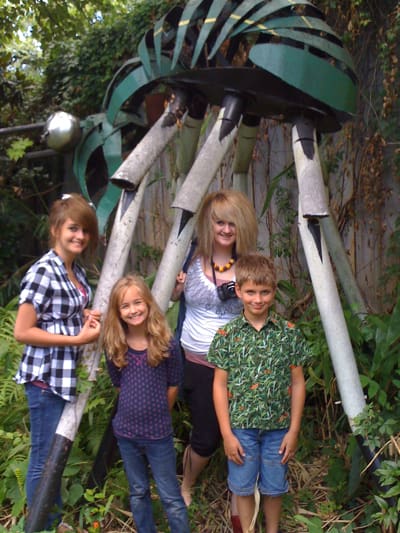 Group of kids by large outdoor sculpture