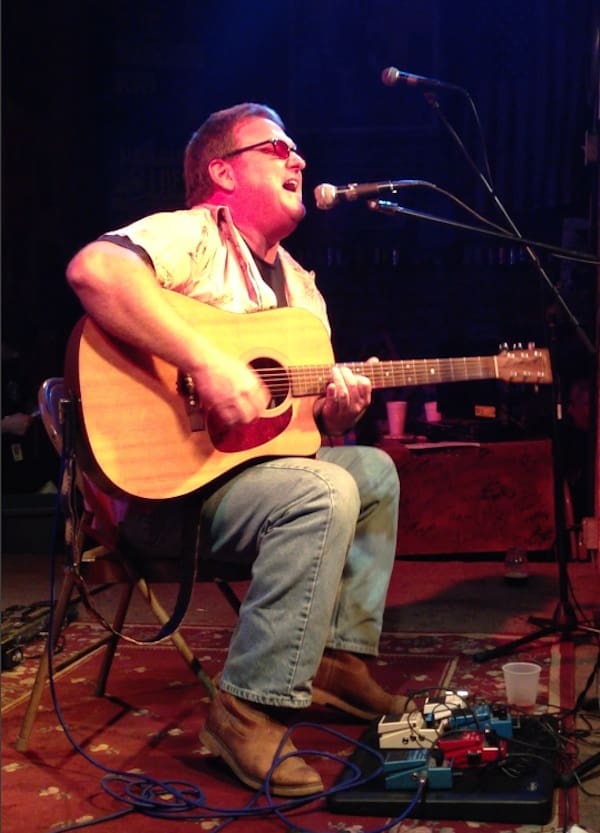 Acoustic guitarist in a live performance.