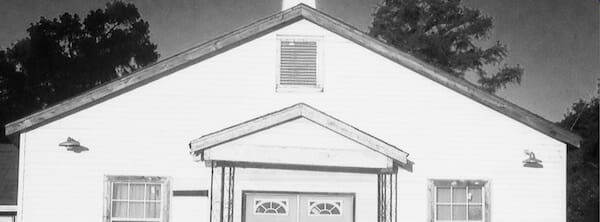 White building with triangular roof