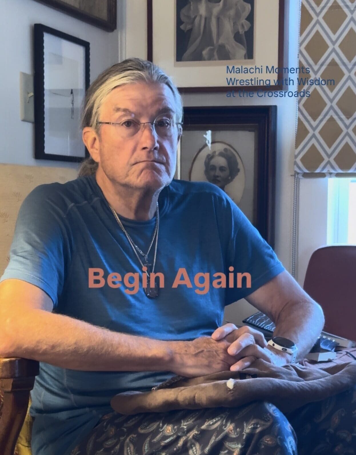 Man sitting cross-legged indoors holding bag