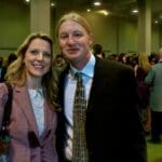Two people smiling at indoor reception