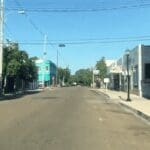 Empty street lined with small buildings