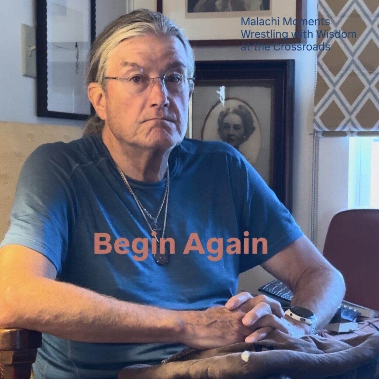 Man sitting cross-legged indoors holding bag