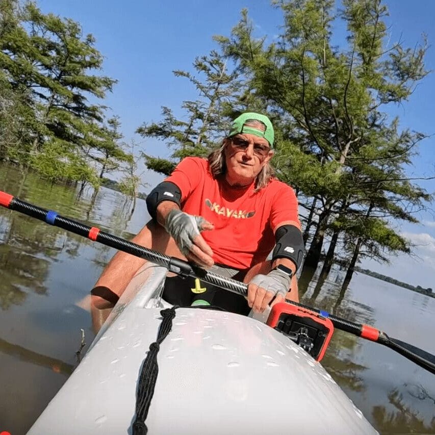 Man kayaking in scenic lake