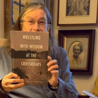 Person holding a book in cozy room.